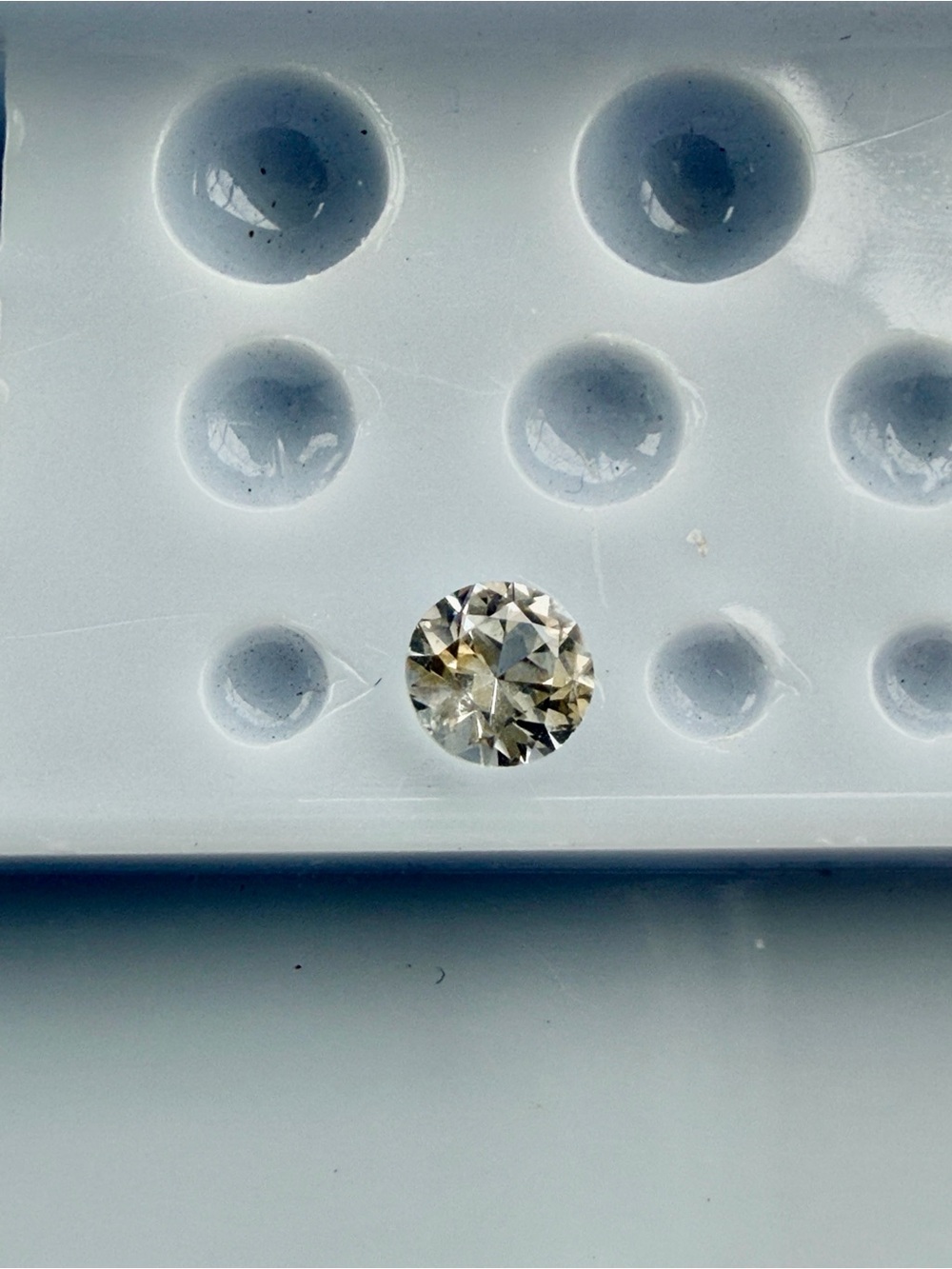Light yellow Sapphire .47 carats 4.5mm round in lucite box